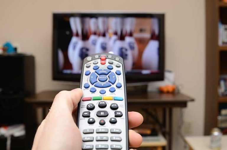 remote-control-in-hand-infront-of-tv